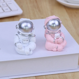 Creative astronaut figurines in pink and white with matte finish for desktop decor