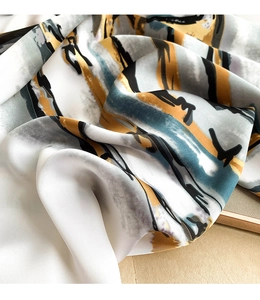 Close-up of silk scarf with abstract oil painting brushstrokes and soft luster