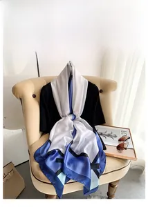 Detailansicht eines Seidenschals mit Schleifenmuster und modischen Accessoires
