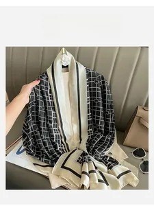 Detail of elegant black and white plaid silk scarf with clover pattern and black borders