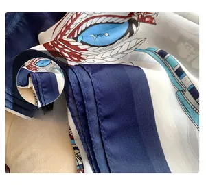 Close-up of premium rolled hem stitching on a silk-like scarf with chain print pattern