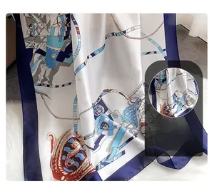 Detail of vintage chain and heraldic print on silky scarf with soft velvet backdrop