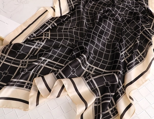 Close-up of elegant plaid silk scarf with satin luster and woven rope texture details