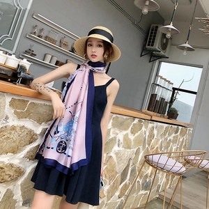 Detail of silk-feel scarf featuring nautical anchor and chain print in pink and navy
