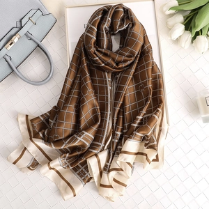British plaid silk scarf in brown and beige with elegant floral patterns and silk luster