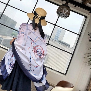 Detail of nautical chain print silk scarf with compass motifs and navy blue borders