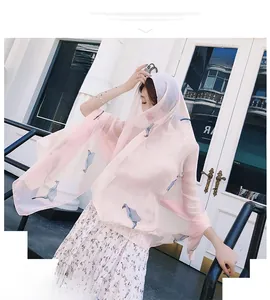 Detail of light pink chiffon scarf with calla lily print and wavy edges for women