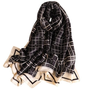 Elegant black and white plaid silk scarf with subtle clover pattern and soft sheen
