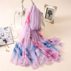Lavender chiffon scarf with floral print draped over a white bag in a luxury scene