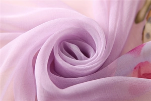 Detail of soft purple chiffon scarf featuring elegant watercolor pink floral patterns