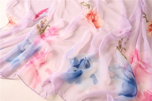 Detailed macro view of sheer lavender floral chiffon scarf with fine rolled edge finish