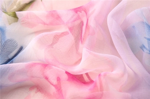Macro detail of soft gradient floral chiffon fabric with elegant translucent texture