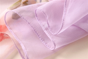 Detail of light purple chiffon scarf showing delicate rolled hem and soft fabric texture