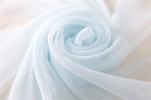 Detailed macro view of light blue chiffon scarf showing soft pleated texture and drape