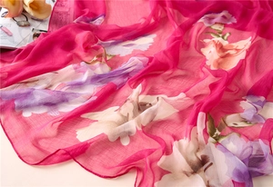 Close-up of lightweight rose chiffon shawl with artistic purple and white floral patterns