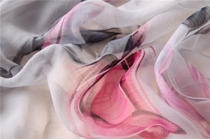 Detail of soft pink ink floral pattern on sheer, lightweight silk-like chiffon fabric