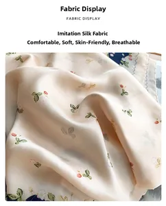 Detailed macro shot of faux silk fabric featuring small floral and strawberry prints