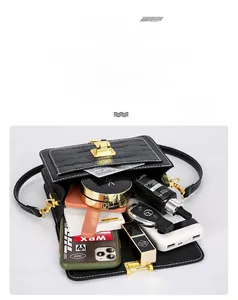 Top view of black crocodile pattern crossbody bag showing spacious interior capacity