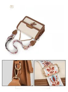 Detail of cream and caramel crossbody bag featuring printed wide strap and metal chain