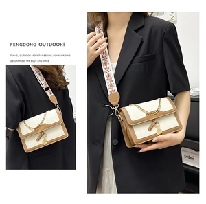 Detail of crossbody bag featuring bohemian wide strap and beige quilted leather texture