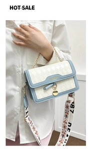 Detail of white quilted crossbody bag with bohemian wide strap and gold chain strap