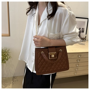 Brown quilted chain bag shown on model highlighting its capacity and stylish daily look