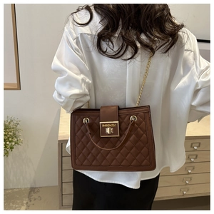 Detail of dark brown quilted leather bag featuring gold chain and HANBAIGE metal lock