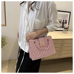 Pink quilted chain handbag with elegant gold metal lock and leather top handle
