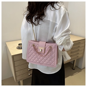 Detail of pink quilted tote bag showing golden turn-lock clasp and metal chain strap