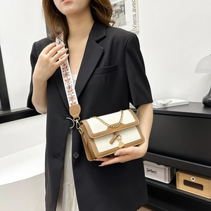 Quilted beige and brown crossbody bag with embroidered strap and gold chain detail