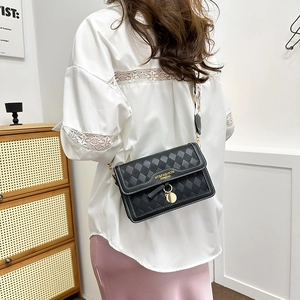 Retro black quilted crossbody bag with white stitching and colorful wide strap