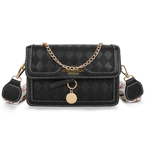 Classic black quilted crossbody bag with golden hardware and ethnic style wide strap