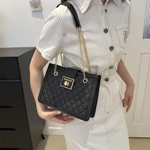 Classic black quilted shoulder bag with golden chain strap and magnetic snap closure