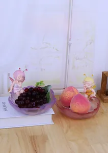 Artistic petal-shaped snack bowls in purple and amber with cute fairy figurines