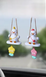 Detail of happy duck car rear view mirror charms with resin swings and cute bags