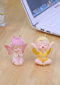 Close-up of cute fairy resin figurines for car interior and office desk decoration