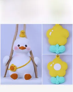 Close-up of creative cartoon duck car pendant and yellow flower tag with detail view