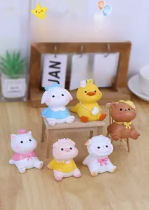 Detailed view of six cute resin animal figurines on a warm wooden office desk setup