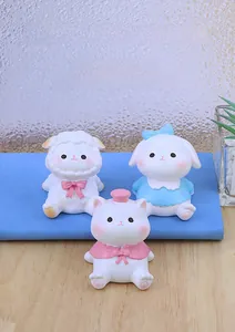 Close-up of cute resin animal figurines including a sheep, rabbit, and cat in macaron colors