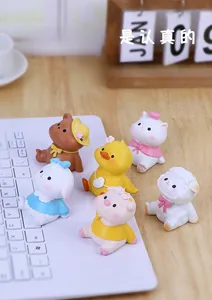 Close-up of cute 6-piece resin animal figurines on a desktop with keyboard and calendar