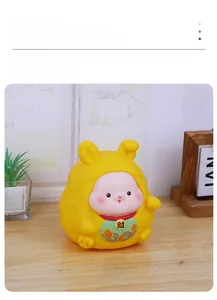 Macro detail of yellow lucky rabbit money box featuring golden Fortune character