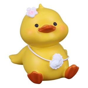 Cute yellow duck figurine with white flower and cloud bag for car dashboard or desk
