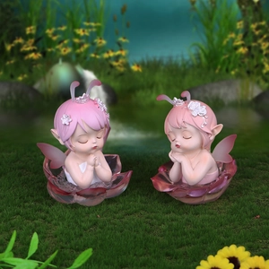 Pink fairy blind box figures with transparent wings on flower base in nature