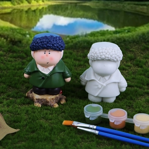 DIY graffiti doll kit with colored figure, white resin blank, paints, and brushes