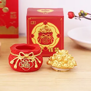 Detail of fortune money bag with removable gold ingot lid and red gift box packaging