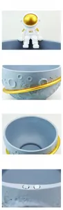 Detail of resin astronaut storage bowl showing moon texture and magnetic base