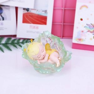Cute cartoon flower fairy night light with sleeping angel figurine on green leaf base