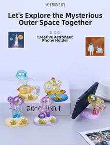 Detail view of astronaut phone stand with iridescent gradient finish and star base