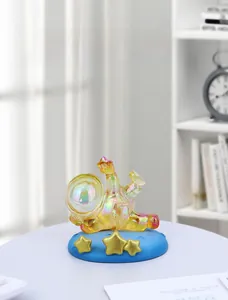 Macro view of a colorful astronaut phone stand with golden stars on a blue base