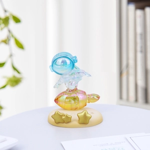 Iridescent astronaut and rocket phone stand decor for creative desktop organization